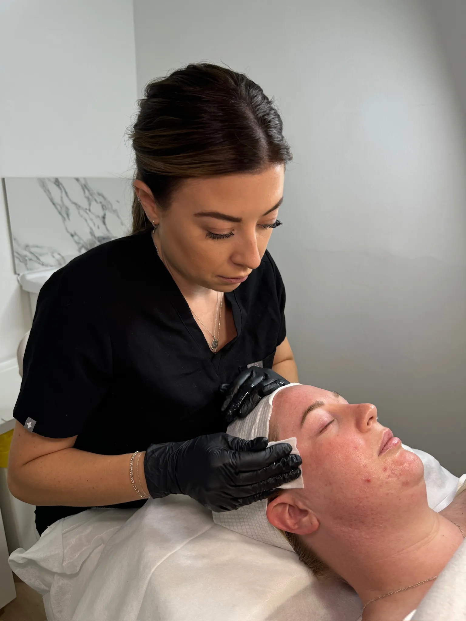 Emma at Pearl Skin Studio carrying out a facial treatment for a client